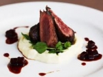 Baked goats cheese with pepper seared kangaroo and red wine sauce